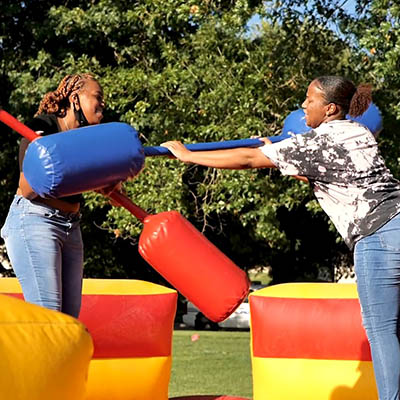 Two students laugh while participating in a welcome week game
