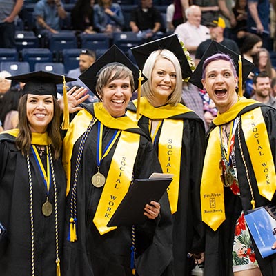 A group of graduates smile for a photo