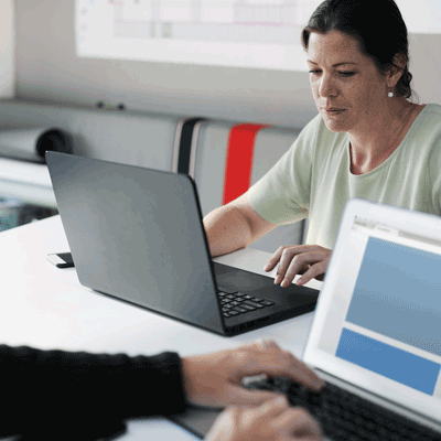 instructor working on a laptop