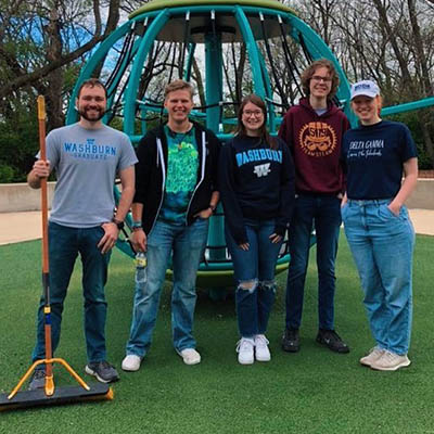 Students pose for a photo at a playground during The Big Event.