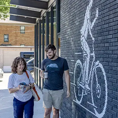 students walking by local business