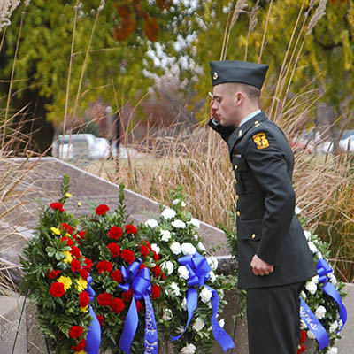 A soldier salutes the Memorial plaque.
