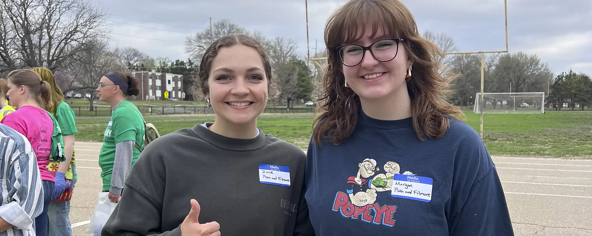 Community service students smile at an event.