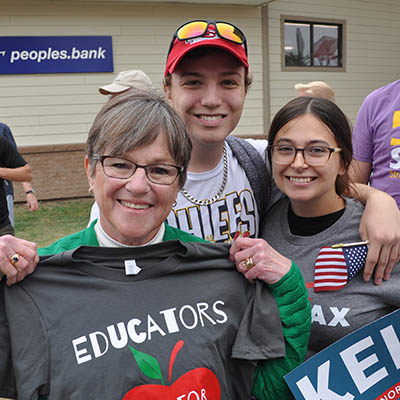 two students with professor smiling at WTE event