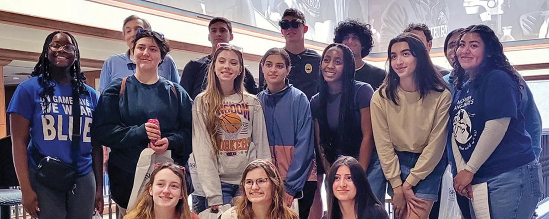 group of 16 students posing for a photo in Morgan Hall lobby