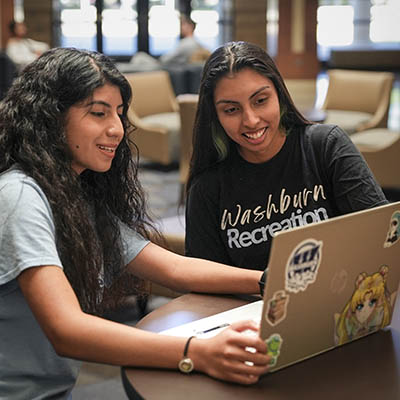 Two female students viewing a laptop