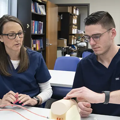 A faculty member mentors a health sciences student.