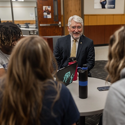 Dean Sollars talks with business students.