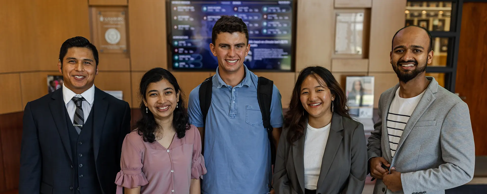 A group of international students smile.
