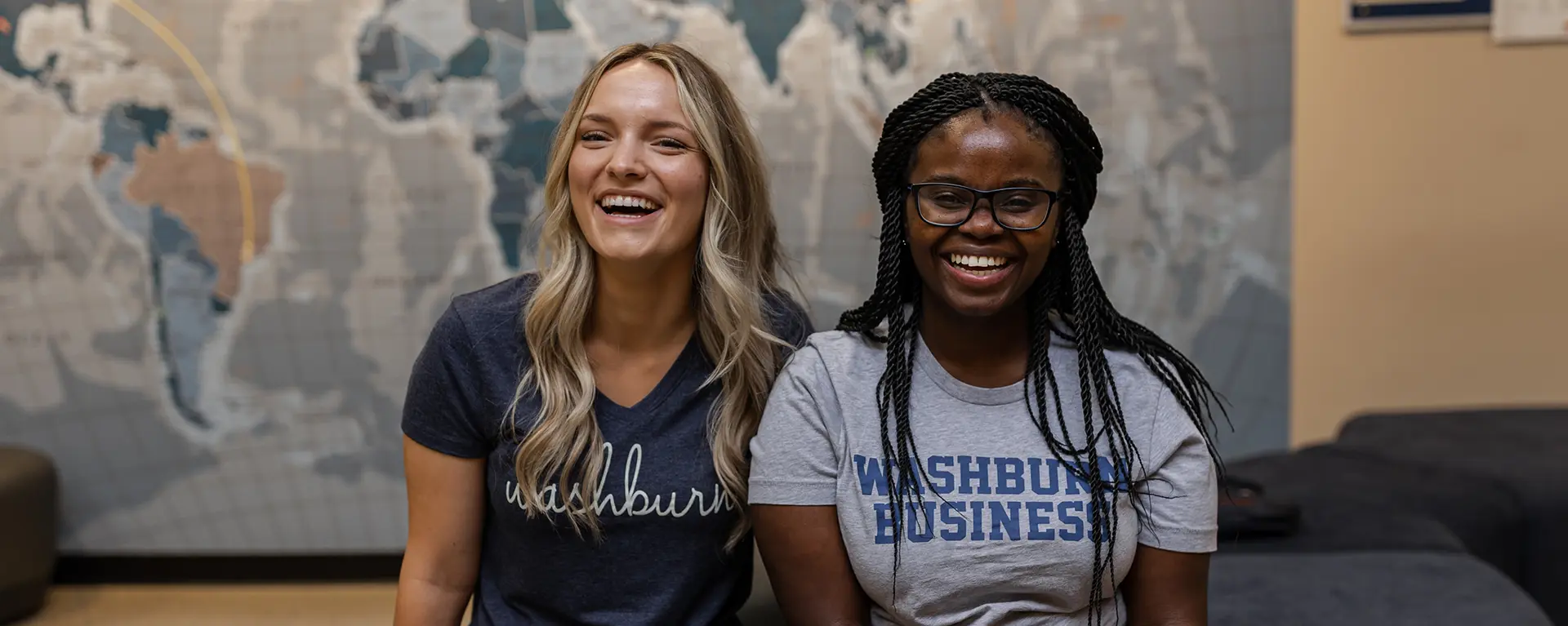 Two business students smile.