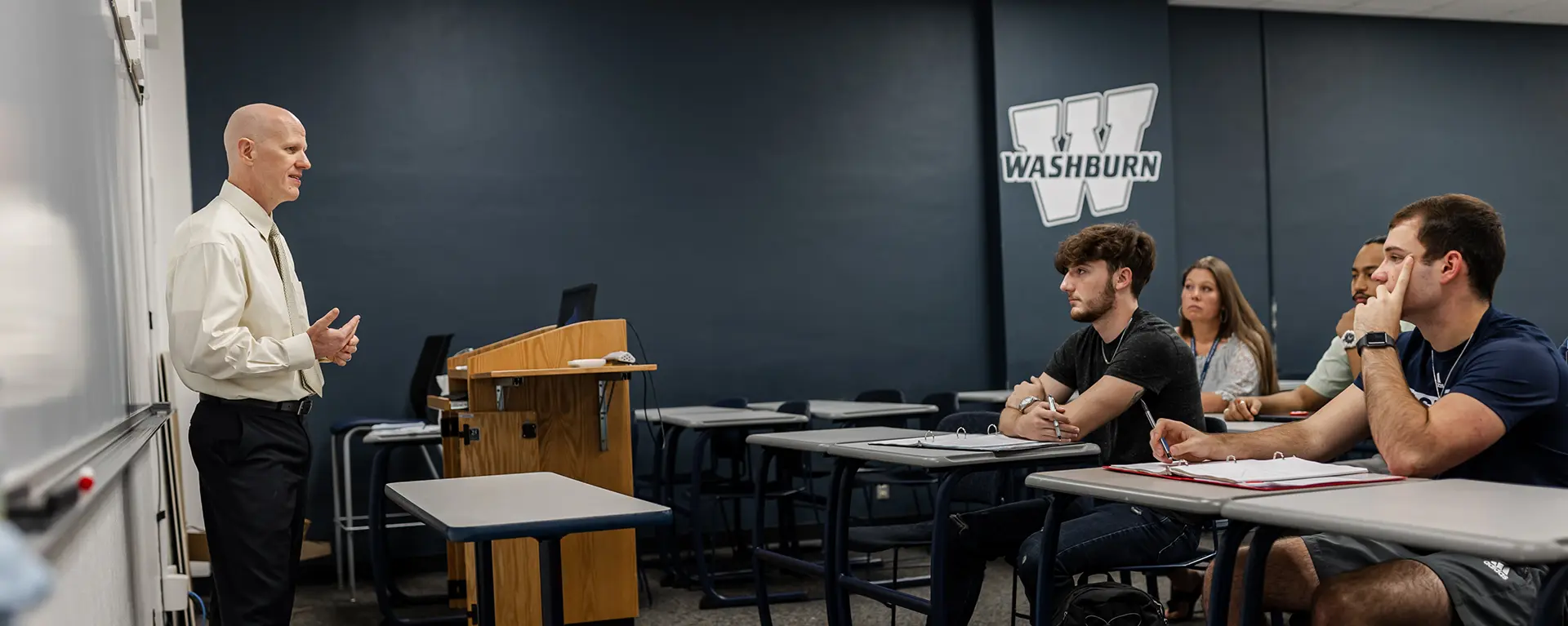 A business professor teaches an MBA class.