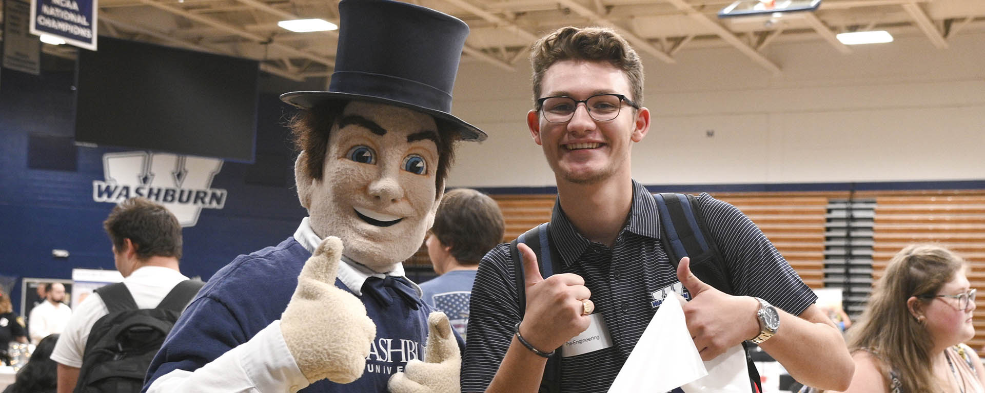A student poses with Mr. Ichabod at a career fair.