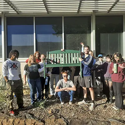 Students with a garden bench.