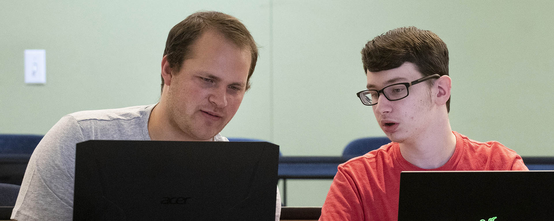 Computer information science students study cybersecurity techniques in class.