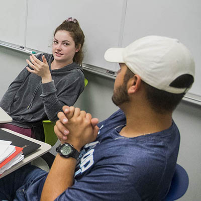 two students talking in class