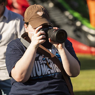 A journalism student takes notes during an interview.