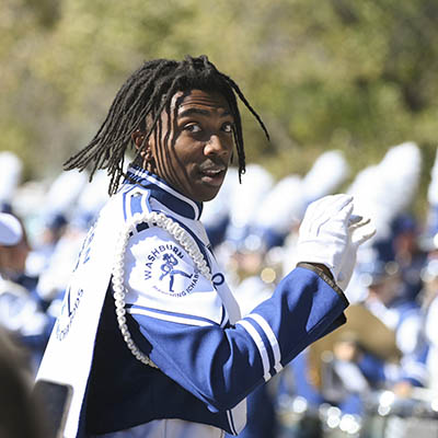 marching band leader in front of band outdoors