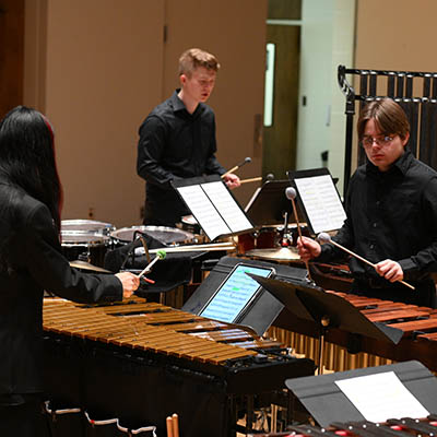 students in orchestra performing