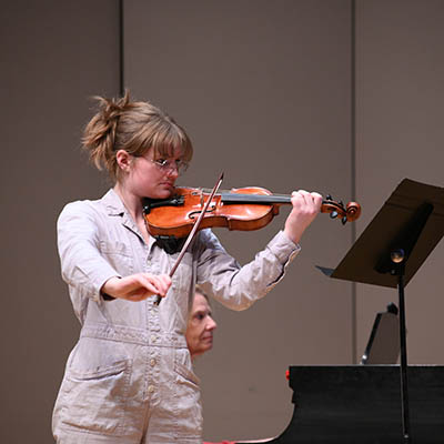 A student plays a violin.