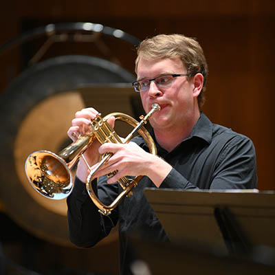 A student plays an instrument during a wind concert