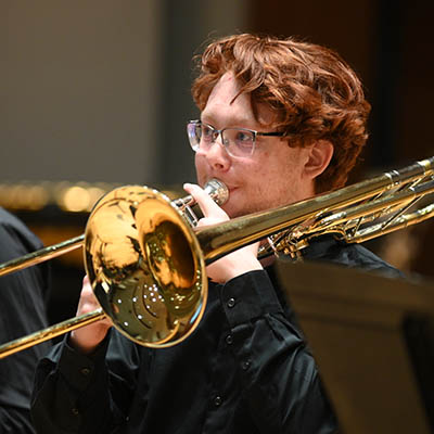 A student playing a trumpet.