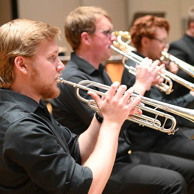 A student playing a trumpet.
