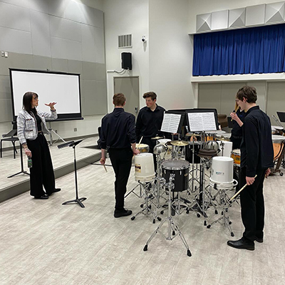 music students with instructor in class