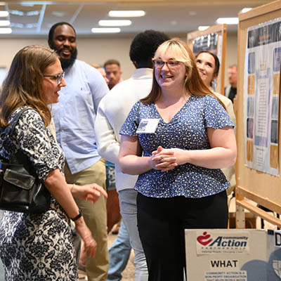 Students and a sociology professor discuss a class project.