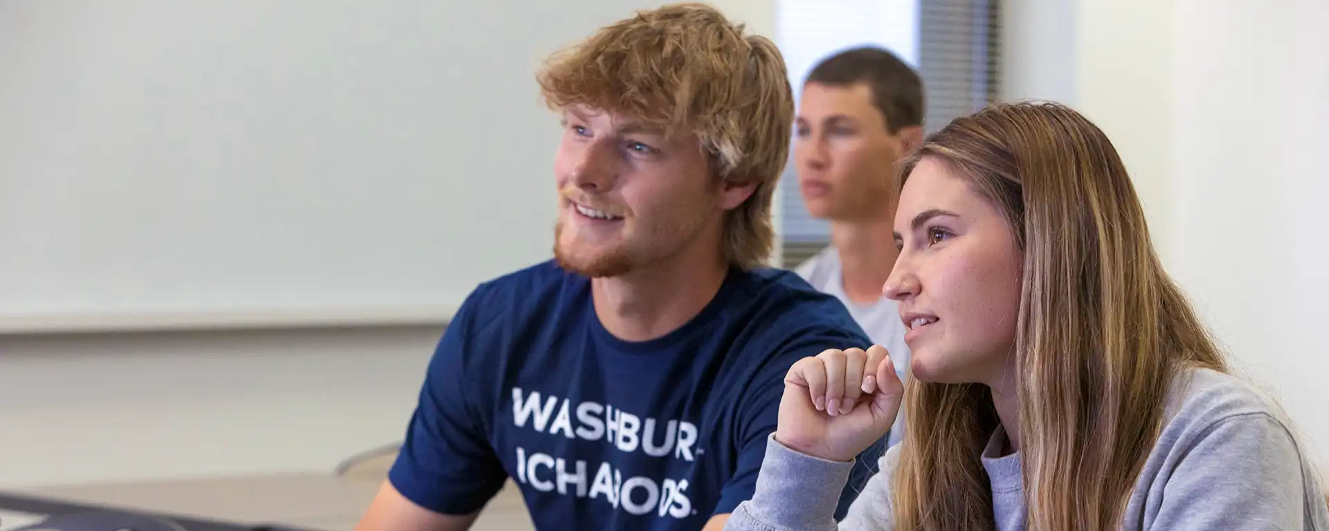 two students in class looking forward from desks