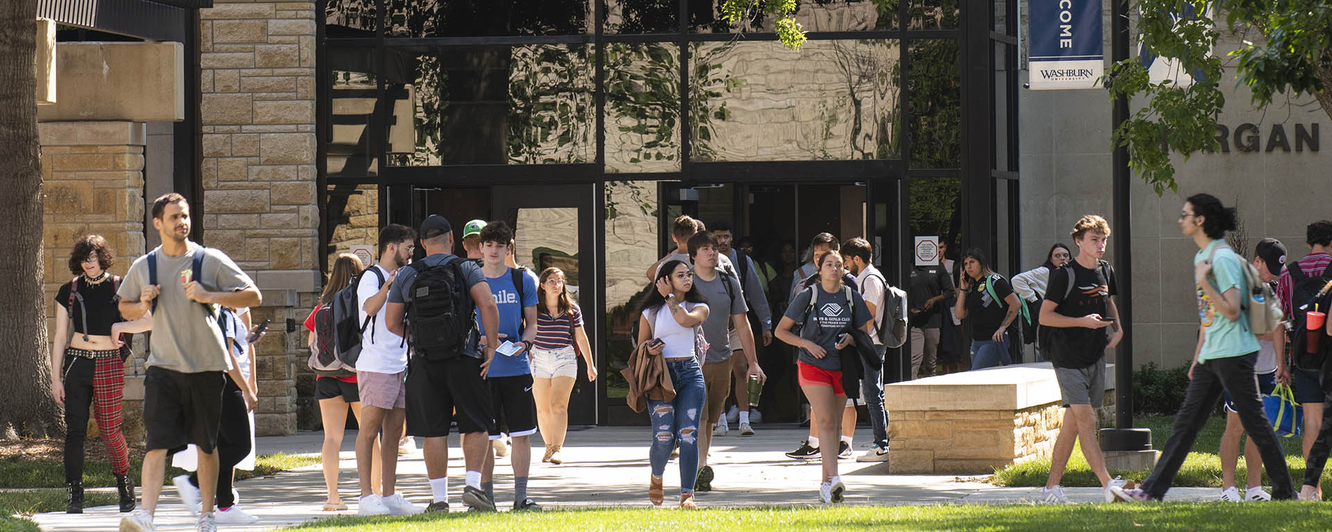 Students exit Morgan Hall on a spring day.