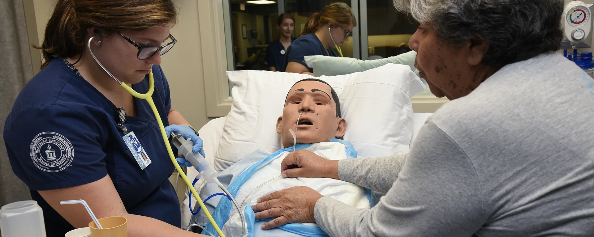 School of Nursing students practicing in lab