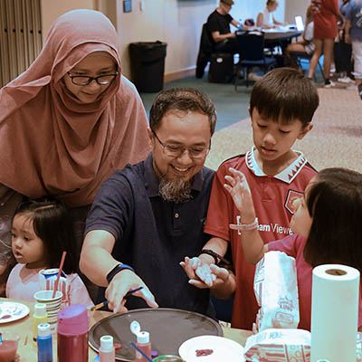 A Washburn professor makes a craft with his family on Family Day.