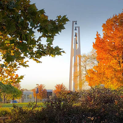 campus bell tower with fall trees