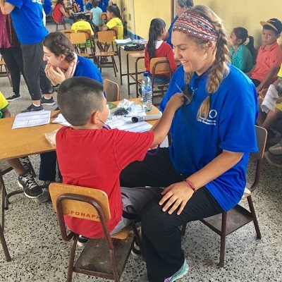 A Washburn nursing students working with a child in a Guatemalan clinic.