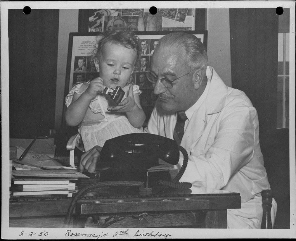 Rosemary in her father's office