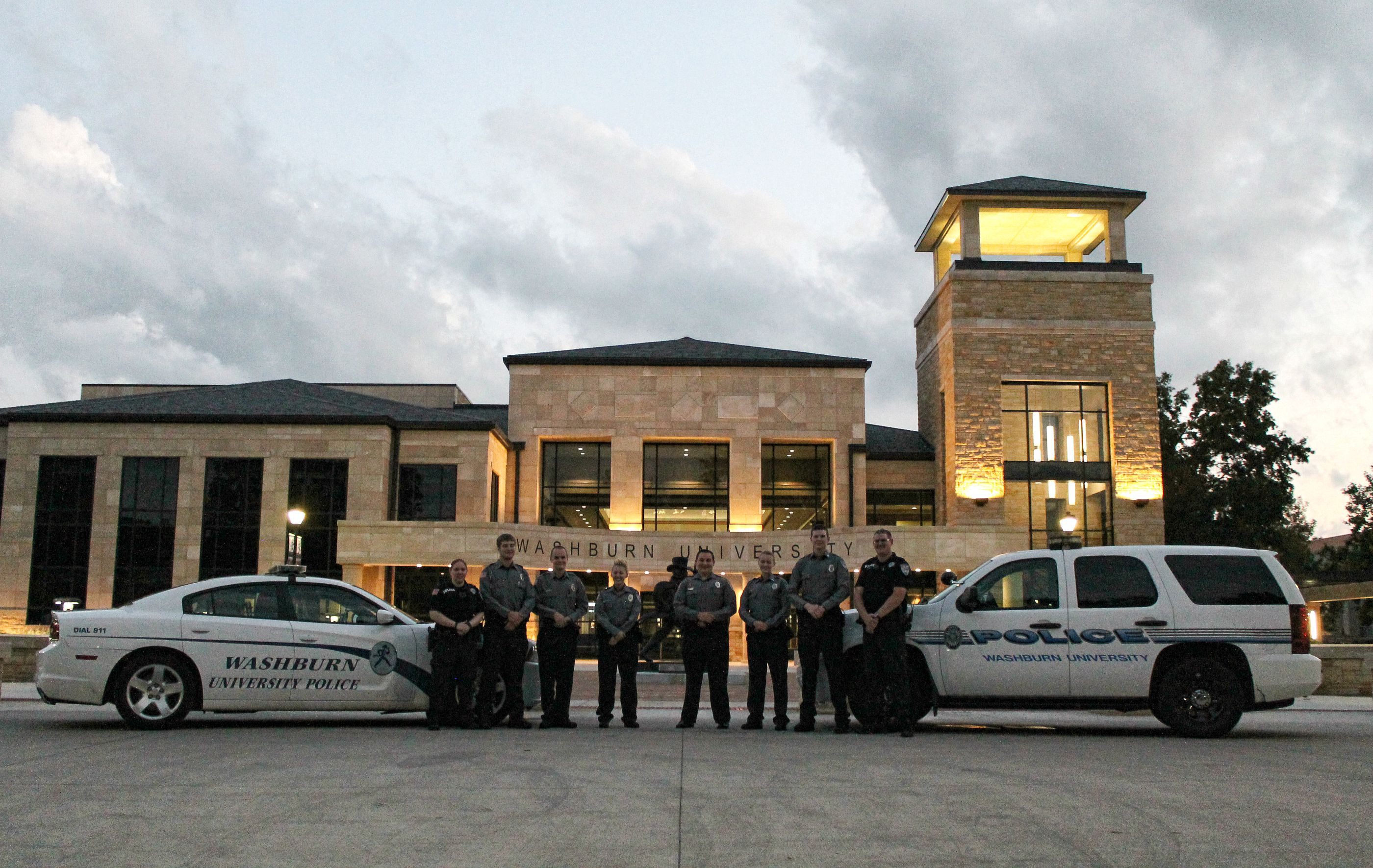 Washburn Police posing with their police cars in front of Morgan Hall.