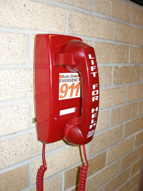 Image of red 911 phone hanging on wall
